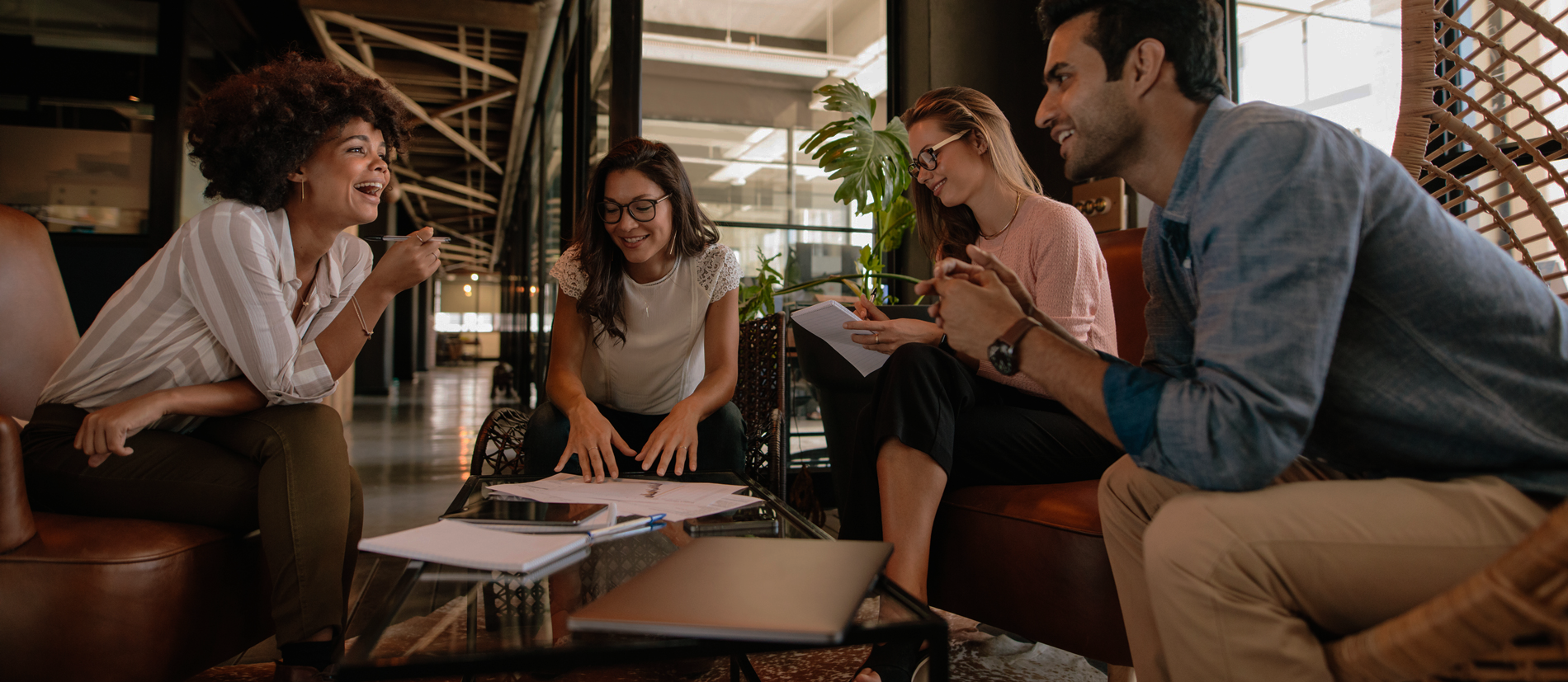 people sitting around a coffee table working