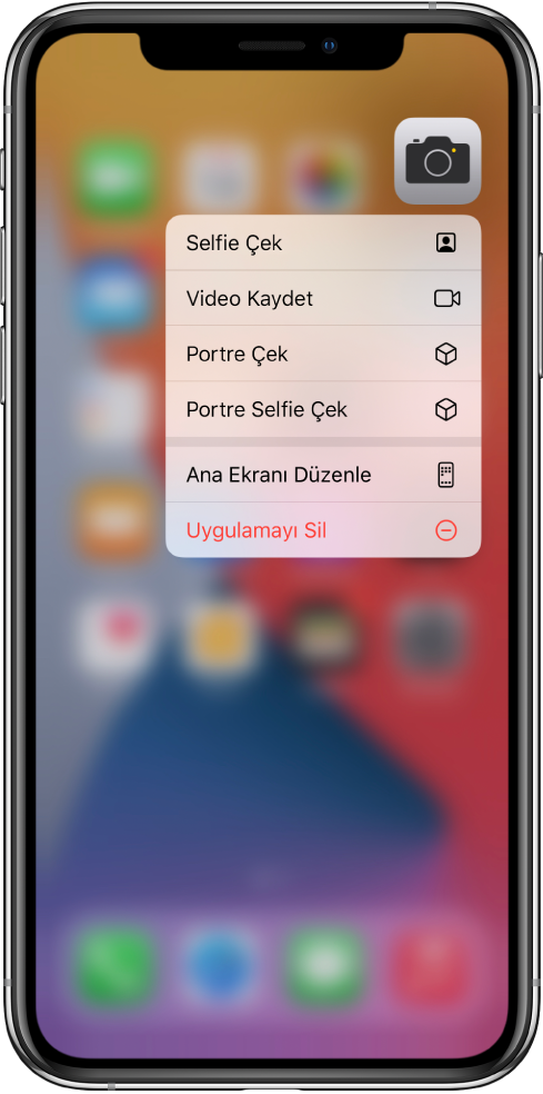 Ana ekran bulanıklaşır, Kamera uygulamasının altında Kamera’nın hızlı eylem menüsü görünür.