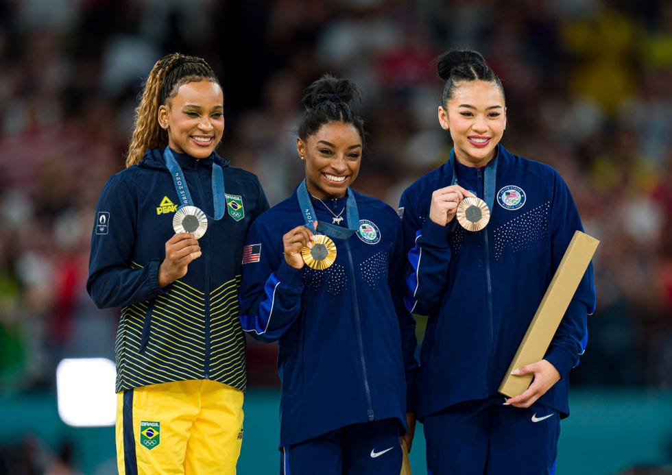 paris, france august 01 gold medalist simone biles of team united states c, silver medalist rebeca andrade of team brazil l and bronze medalist sunisa lee of team united states r pose on the podium at the artistic gymnastics womens all around medal ceremony on day six of the olympic games paris 2024 at bercy arena on august 01, 2024 in paris, france photo by andy cheunggetty images