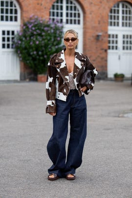 copenhagen, denmark august 07 a guest wears brown cow print jacket, dark denim jeans outside baum  pferdgarten during day three of the copenhagen fashion week cphfw ss25 on august 07, 2024 in copenhagen, denmark photo by christian vieriggetty images