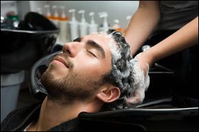 washing a man's hair in salon