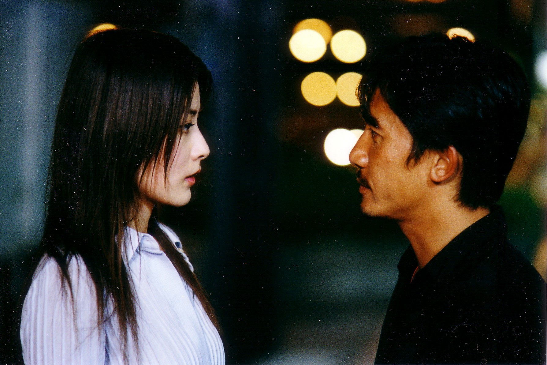 Kelly Chen and Tony Leung Chiu-wai in Infernal Affairs (2002)