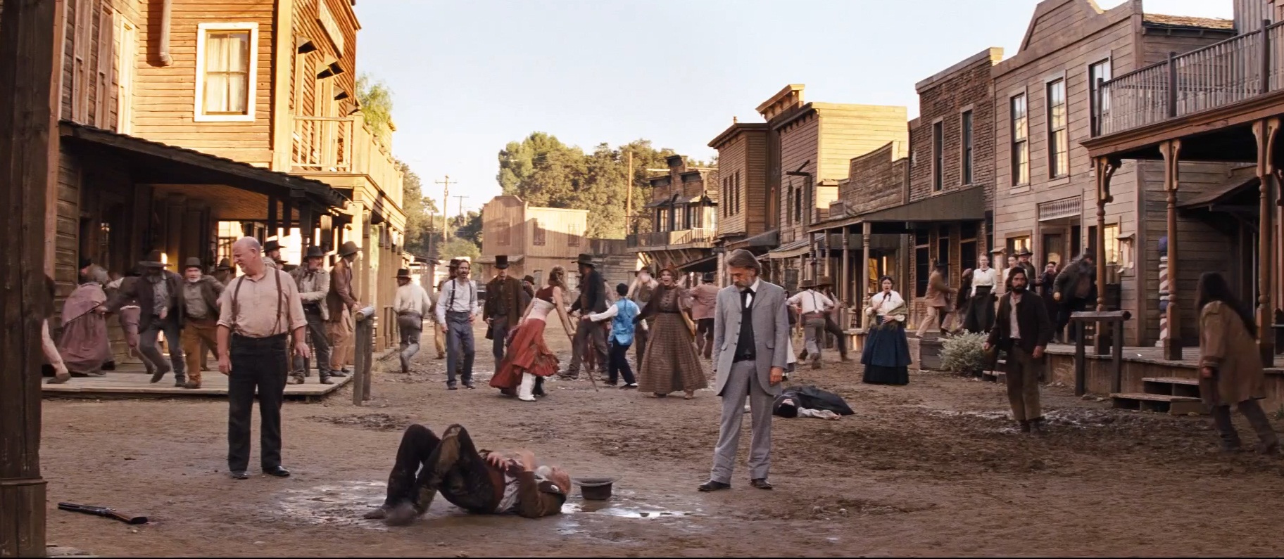 Schultz kills the sheriff.  The townsfolk run.  Mark Amos, as Beard Man, on the far right.