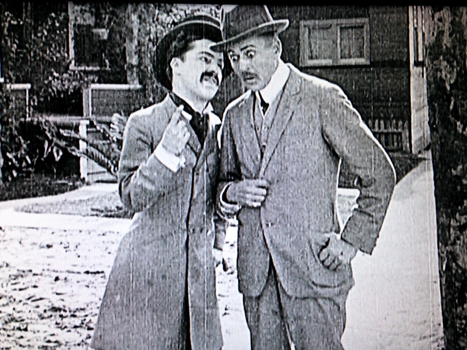 Charles Chaplin and Henry Lehrman in Making a Living (1914)