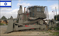 IDF armored D9R or D9T with add-on slat armor against anti-tank weapons parking in IDF outpost