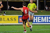 Pearce kicking a football