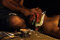 Applying make-up to a Kathakali artist