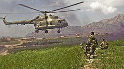 ISAF forces pull security for the safety of the pilots and team of an Mil Mi-17 helicopter as it leaves the Gulistan district in 2009.