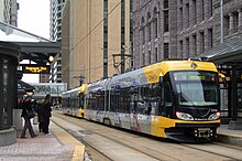 Yellow light rail across the street from old city hall downtown