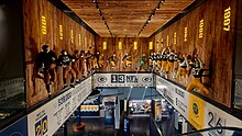 Photo from the second floor of the Packers Hall of Fame looking down the stairs with various exhibits showing