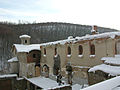 Burned monastery lodgings covered in snow