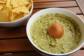 A guacamole mix (right) used as a dip for tortilla chips (left)