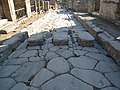 Wheel ruts around a crosswalk in Pompeii.