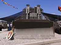 IDF armored D9R with slat armor, front view on the massive bulldozer blade