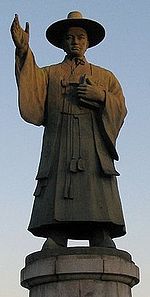 a retouched photo of Saint Andrew Kim Taegon statue