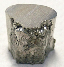 A pitted and lumpy piece of nickel, with the top surface cut flat