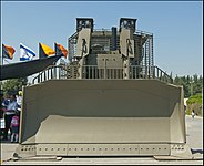 IDF armored D9R with slat armor, front view on the massive bulldozer blade