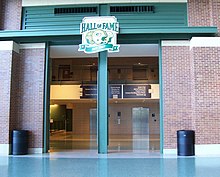 Photo showing an entrance surrounded by brick with the hall of fame logo above