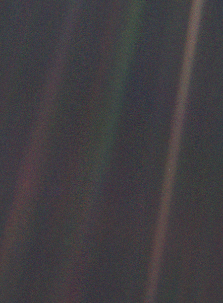 Dark grey and black static with coloured vertical rainbow beams over part of the image. A small pale blue point of light is barely visible.