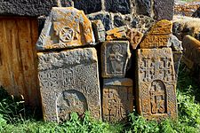 Khachkars lining the exterior wall of the church.