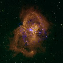 Bright blue stars in a large gold cloud of gas