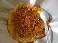 Kerak telor with fried shallots on top.