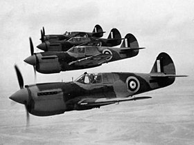 Four single-engined military monoplanes in flight