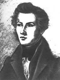 Young man with delicate features wearing a black jacket looking slightly to the viewer's left