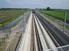 Ballastless double track of the type "Rheda 2000" including concrecte slabs and sleepers, rails, and drainage slits.