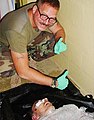 10 - Charles Graner poses over the dead body of an Iraqi prisoner.