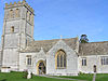 Stone building with square tower.