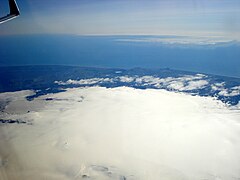 In the foreground, ice cauldrons indicate craters and subglacial high temperature areas.