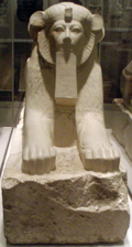 wikipedia:Sphinx of Hatshepsut with unusual rounded ears and ruff that stress the lioness features of the statue, but with five toes – newel post decorations from the lower ramp of her tomb complex. The statue incorporated the nemes headcloth and a royal beard; two defining characteristics of an Egyptian pharaoh. It was placed along with others in Hatshepsut's mortuary temple at Deir el-Bahri. Thutmose III later on destroyed them but they were reassembled by the Metropolitan Museum of Art. Date: 1479–1458 BC. Period: New Kingdom. 18th Dynasty. Medium: Granite, paint.[1]