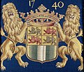 blason encadré de part et d'autre par deux lions jaunes et surmonté par une couronne