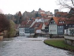 Historical town center of Kronach with the river Hasslach in the foreground.