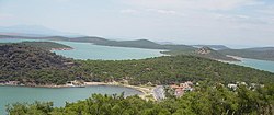 A view of the Çamlık area of Ayvalık and the Ayvalık Islands archipelago in the اژه دنیزی, with the Greek island of Lesbos on the horizon, at left.