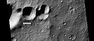 Group of craters that may have struck the surface at the same time after an asteroid broke up. If the craters were formed at different times, they would have wiped away parts of the others. Picture was taken by HiRISE, under HiWish program. Image located in Terra Cimmeria.