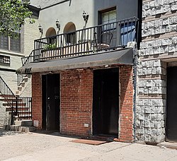 Photograph of an entrance to a building on a city street on a sunny day