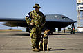 A B-2 Spirit being guarded by a member of the Australian Army at RAAF Base Darwin