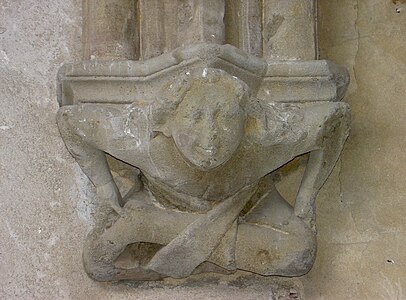 Console d'une des travées de la galerie est de l'abbaye d'Abondance, représentant un petit acrobate souriant, XIVe siècle.