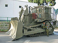 IDF armored D9R with add-on slat armor against anti-tank weapons, in LIC 2005 exhibition (sign removed)