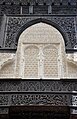 Stucco and wood carvings on one of the lateral galleries of the courtyard