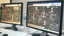 Two computer flat screens showing a plant process management application