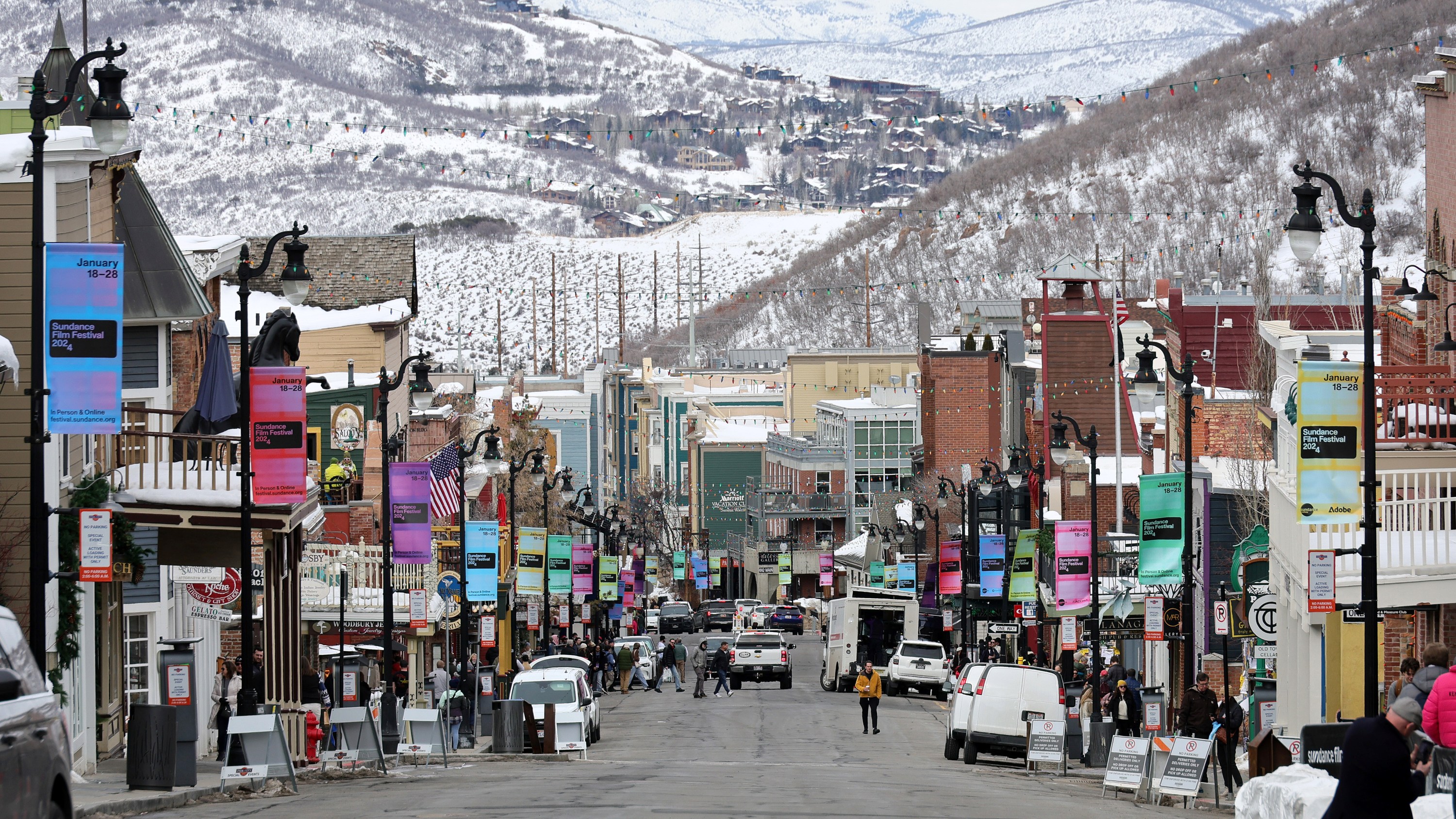 PARK CITY, UTAH - JANUARY 23: Signage hangs from lamp posts as people walk on Main Street during the 2024 Sundance Film Festival on January 23, 2024 in Park City, Utah. (Photo by Dia Dipasupil/Getty Images)