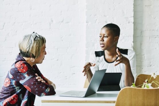 Two business professionals discussing strategy.